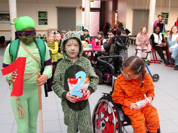 Ein Foto zeigt verkleidete Schüler:innen beim fröhlichen Karnevalsfest an der Brückenschule.