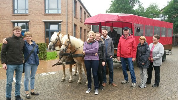 Ein Foto zeigt Christa Holthausen mit ihrer Familie und Mitarbeiterinnen der Pflege